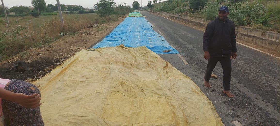 రైతులు ధాన్యం తడవకుండా కప్పిన పట్టలు