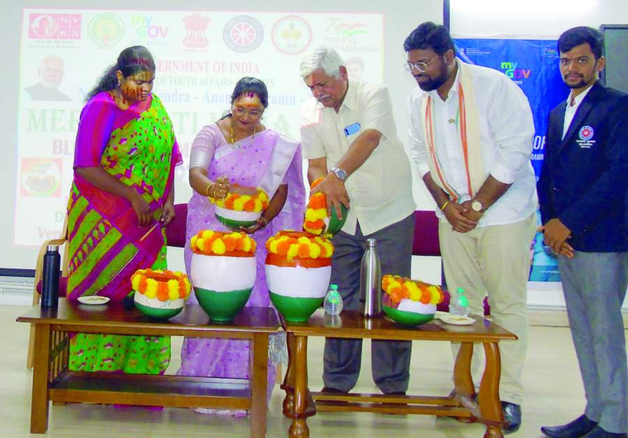   కుండల్లోకి మట్టని పోస్తున్న అతిథులు